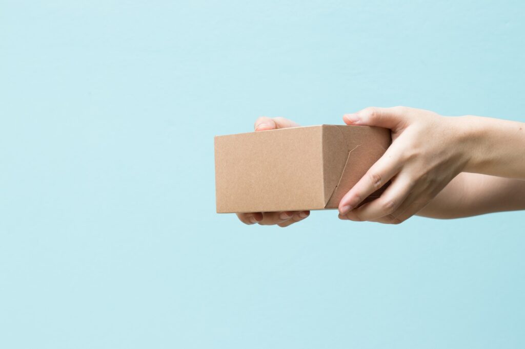 Hand hold box on blue background